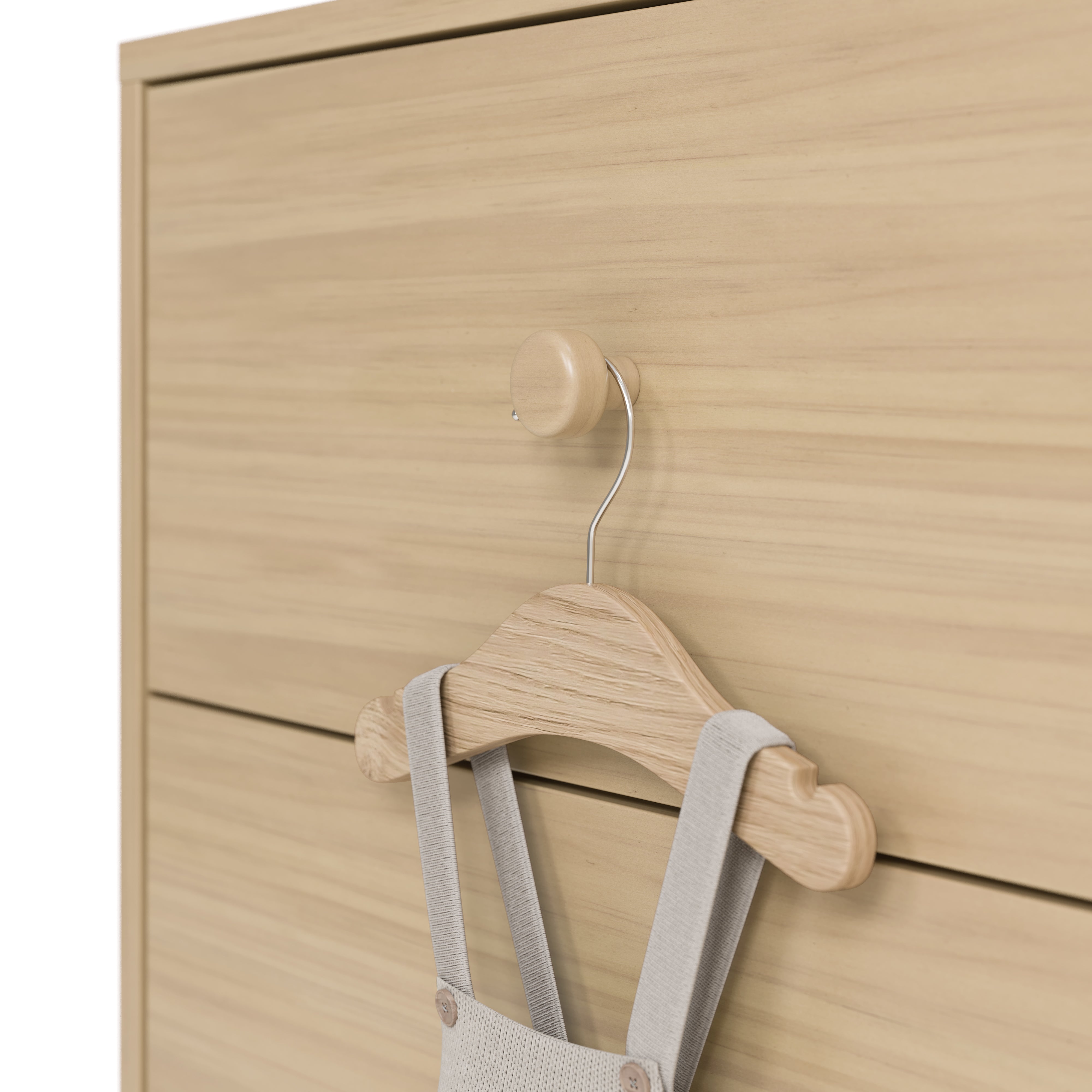 California driftwood 6 drawer dresser close up of drawer knob with baby hanger hanging on it