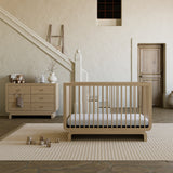 Santorini driftwood 6 drawer dresser in a nursery next to crib
