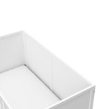 Close-up view of white crib's headboard
