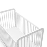 Close-up view of white crib's headboard