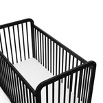 Close-up view of black crib's headboard
