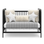 Black crib in toddler bed conversion