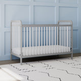 Front view of white crib with pebble gray in nursery