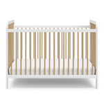 Front view of white crib with driftwood