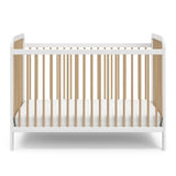 Front view of white crib with driftwood