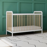 white crib with driftwood in nursery
