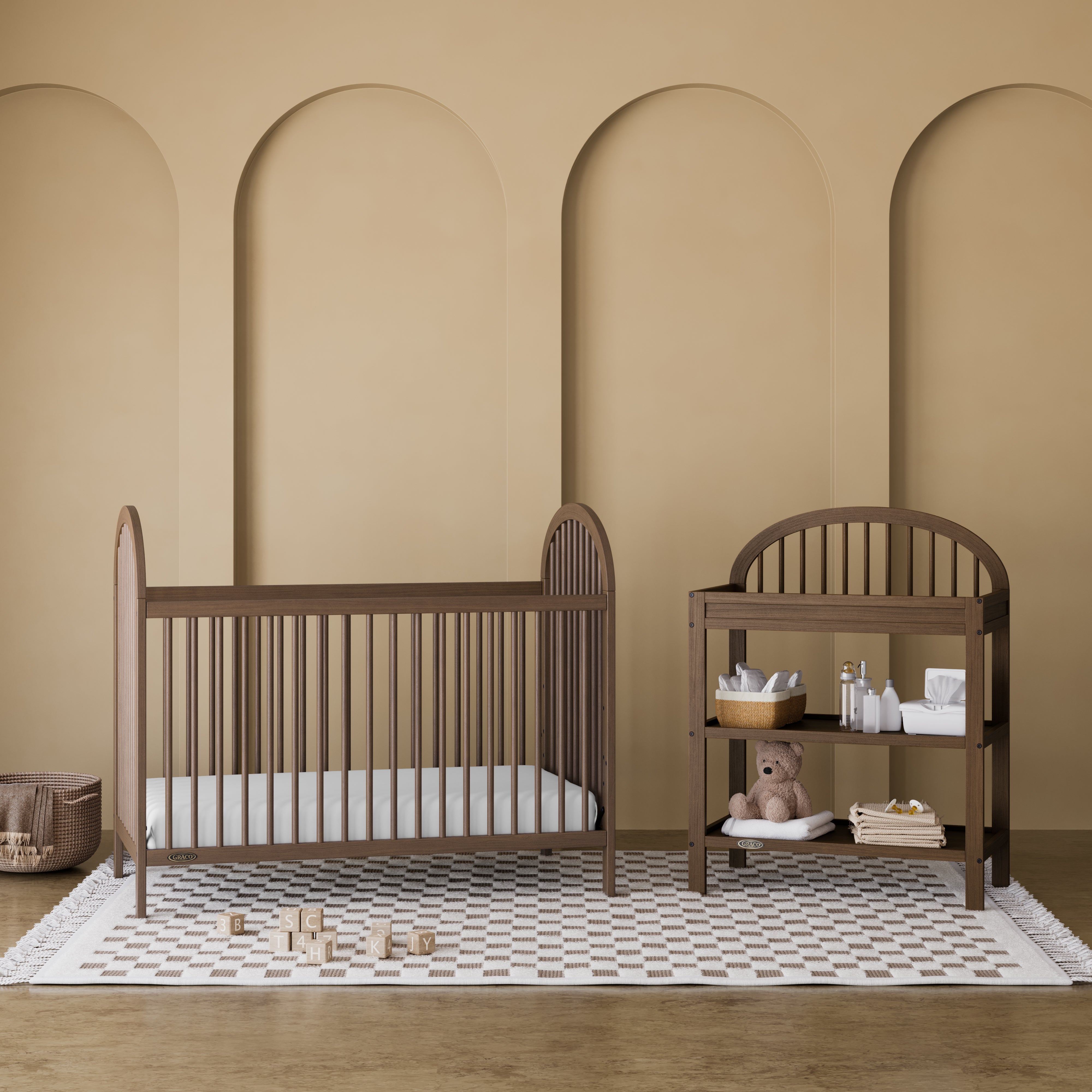 Olivia hazelnut changing table in a nursery next to crib