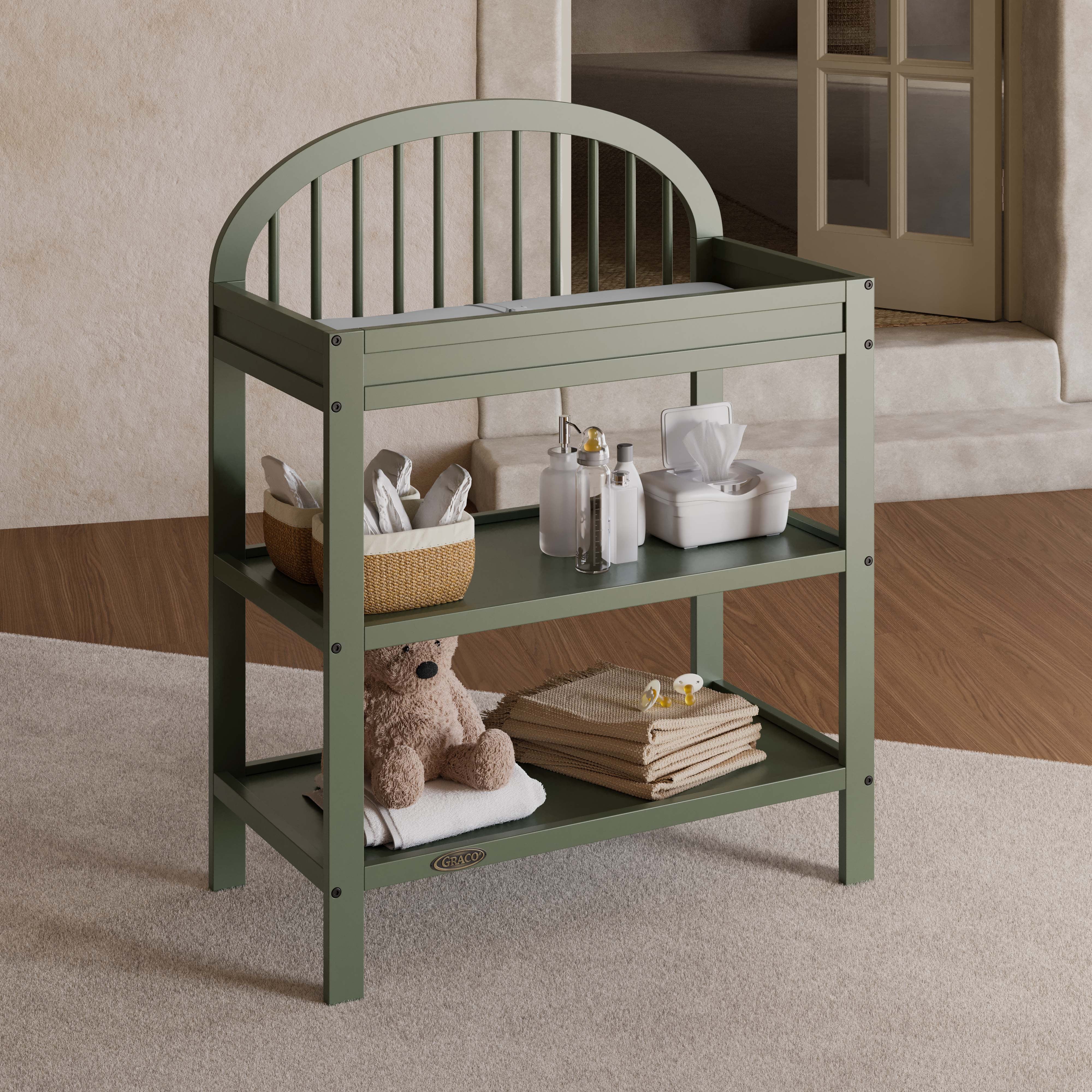 Olivia olive changing table in a nursery