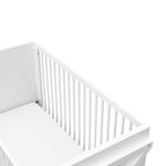 Close-up view of white crib's headboard