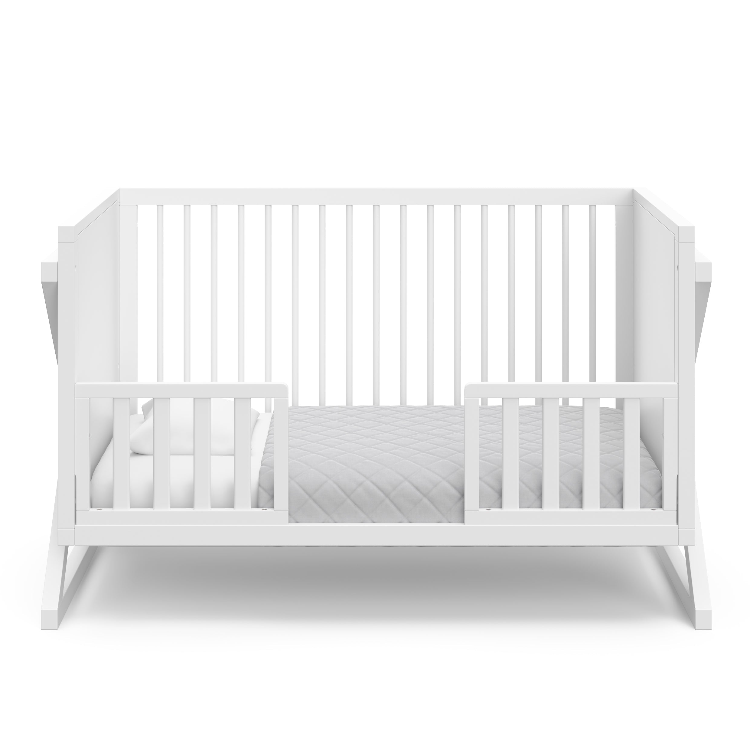 White crib in toddler bed conversion with two safety guardrails