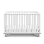 Front view of white crib with pebble gray