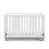 Front view of white crib with pebble gray