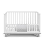 White crib with pebble gray in toddler bed conversion with two safety guardrails