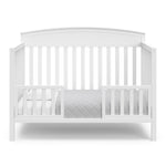 Benton white crib converted to toddler bed with two guardrails