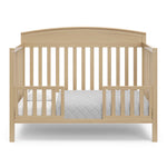 Benton driftwood crib converted to toddler bed with two guardrails