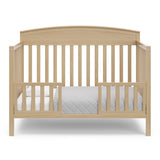 Benton driftwood crib converted to toddler bed with two guardrails