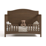 Paris hazelnut crib converted to toddler bed with two guardrails