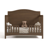 Paris hazelnut crib converted to toddler bed with two guardrails