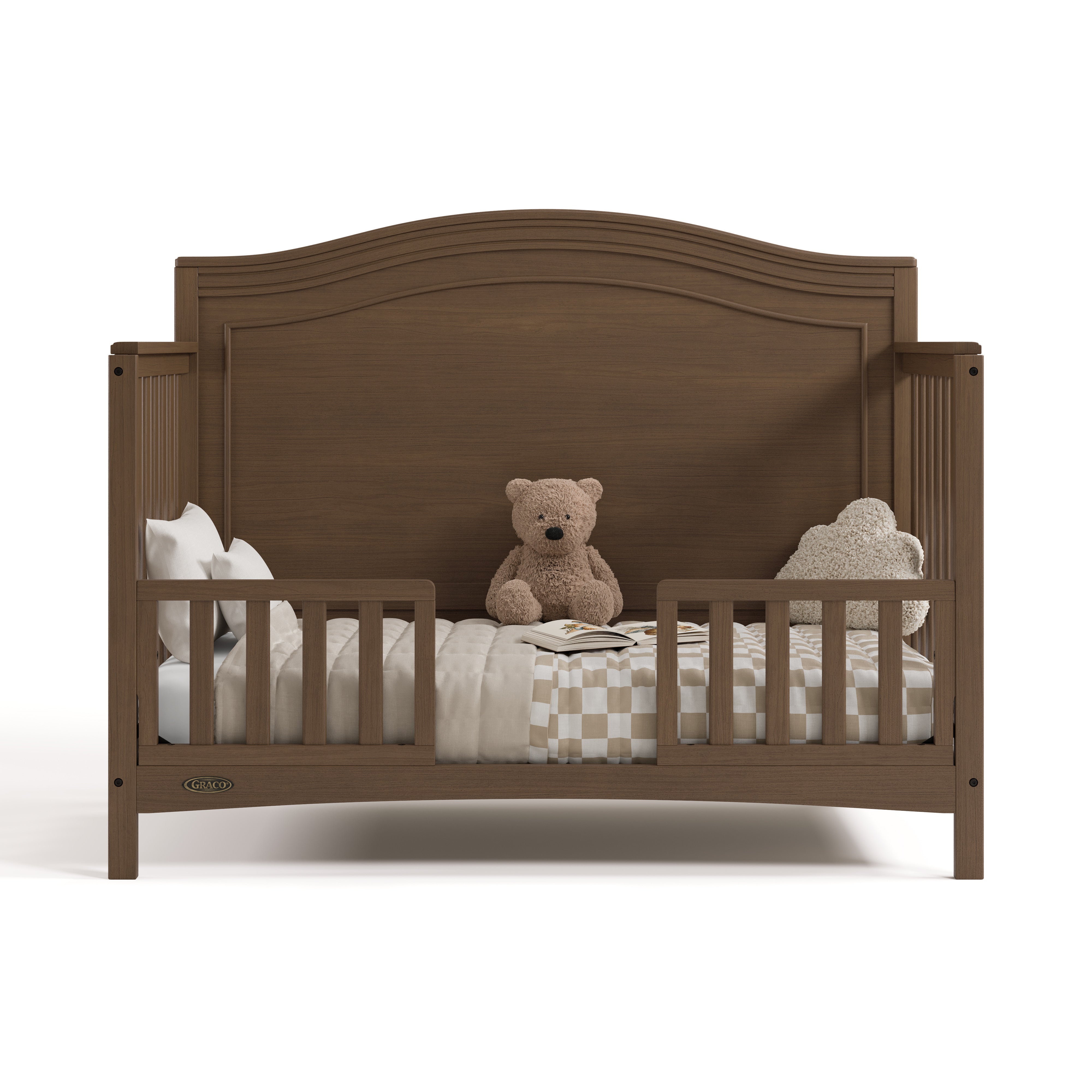 Paris hazelnut crib converted to toddler bed with two guardrails