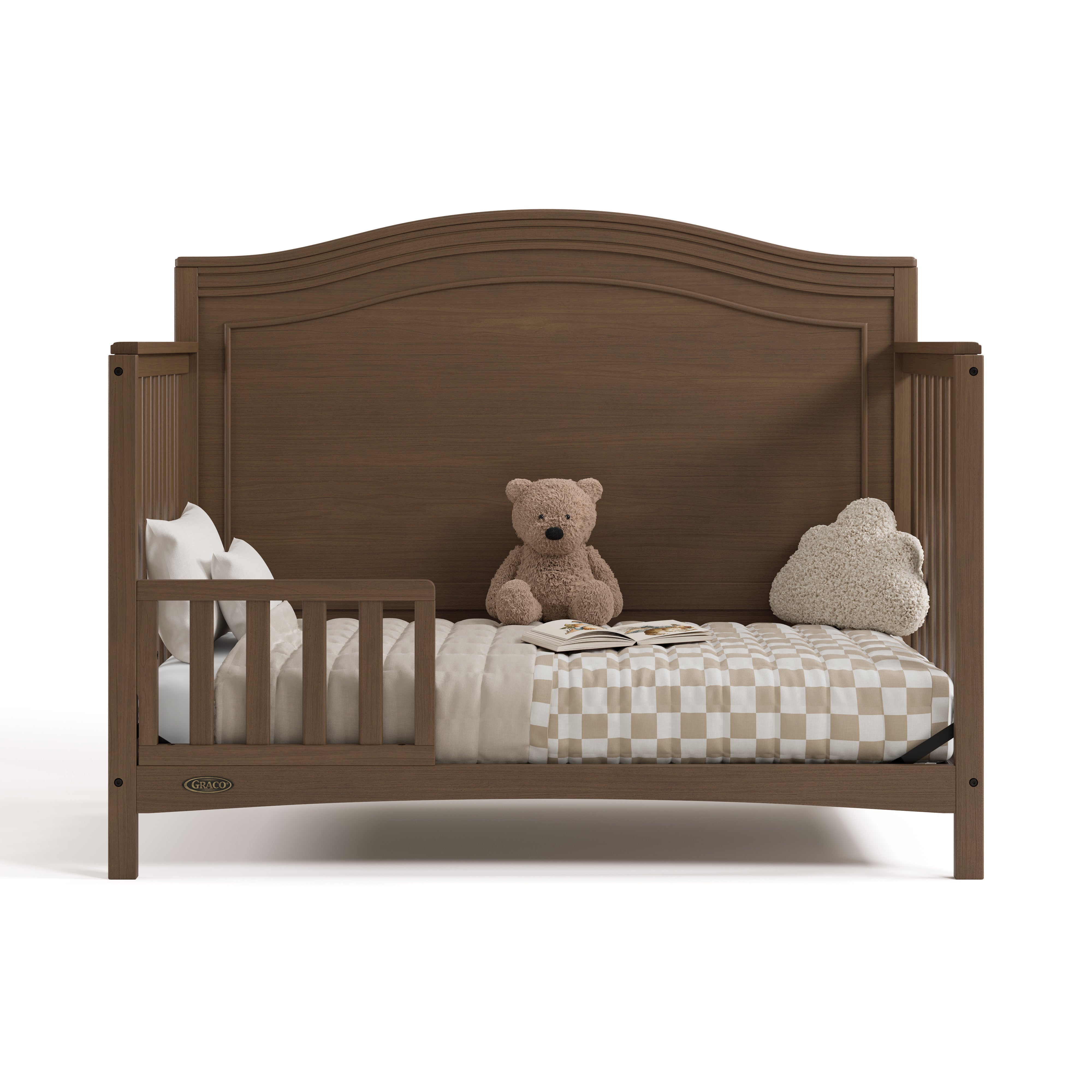 Paris hazelnut crib converted to toddler bed with one guardrail
