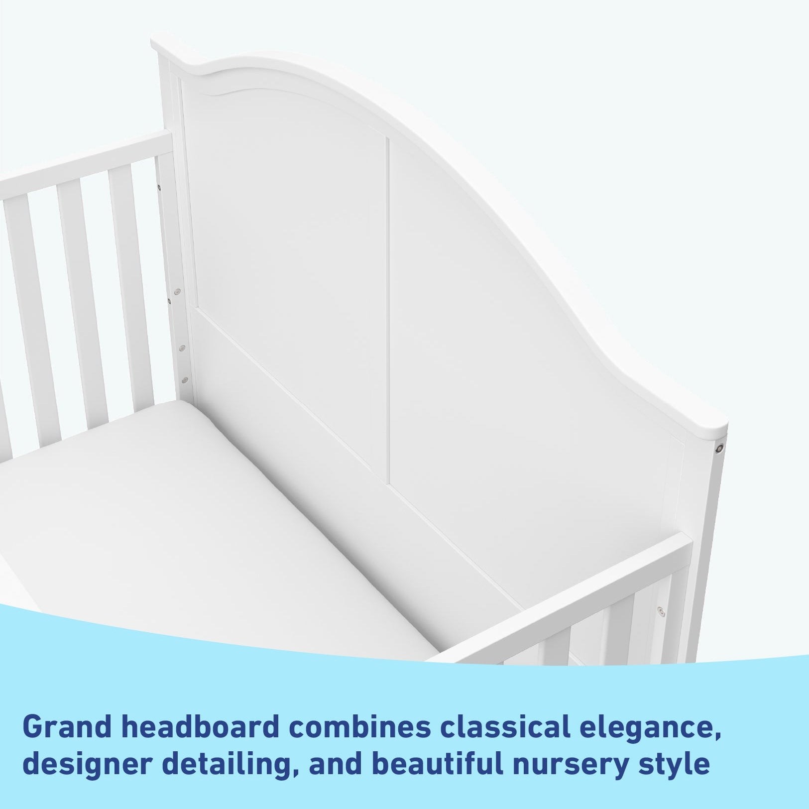 Close-up view of white crib's headboard graphic
