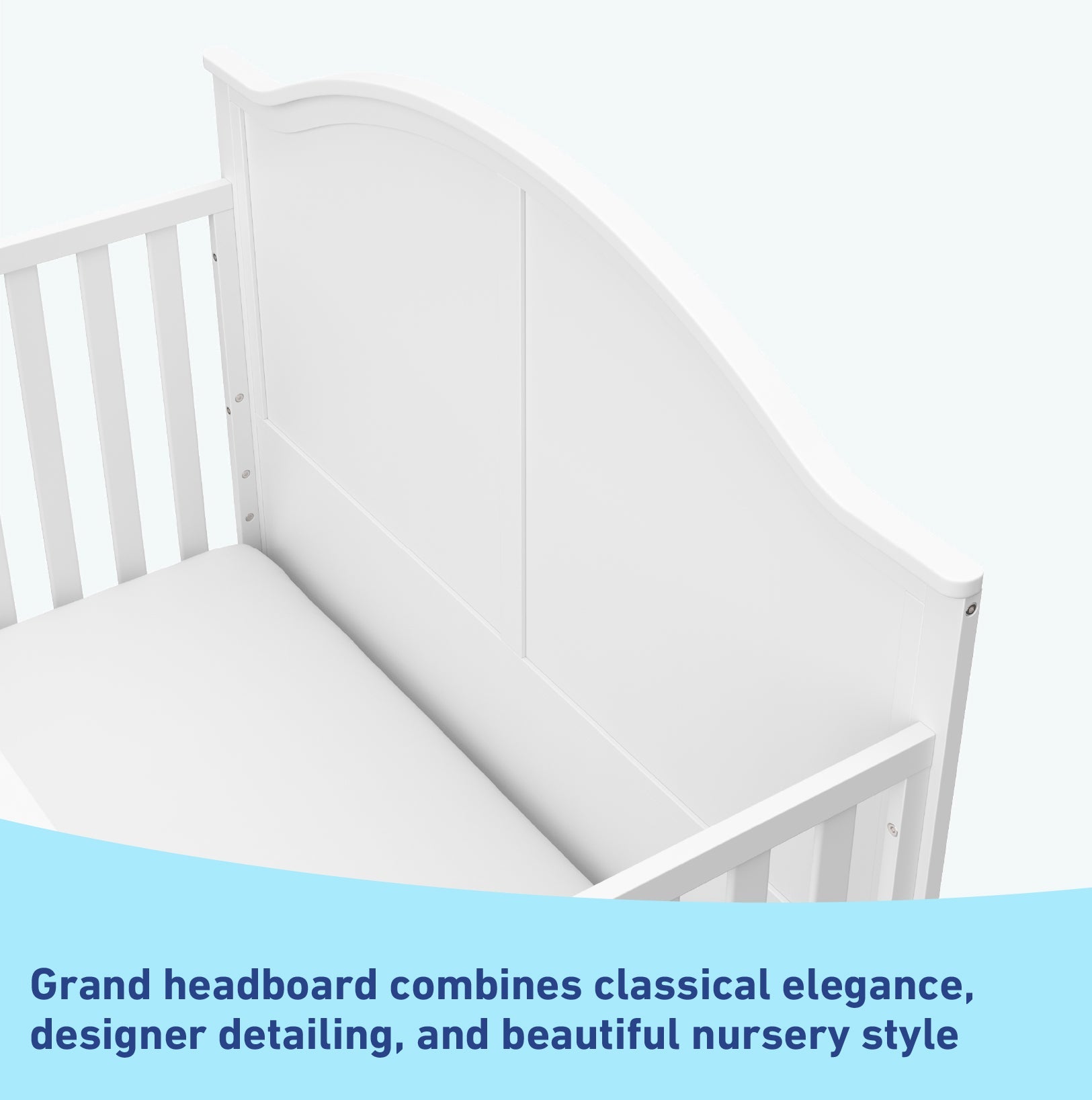Close-up view of white crib's headboard graphic