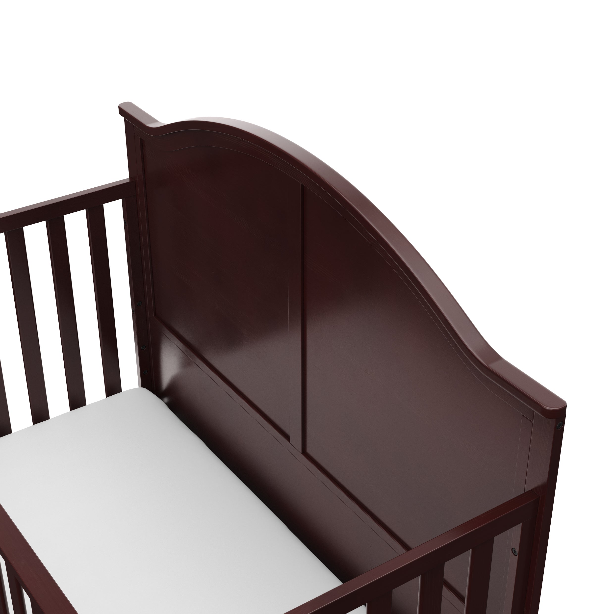 Close-up view of espresso crib's headboard
