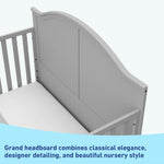 Close-up view of pebble gray crib's headboard