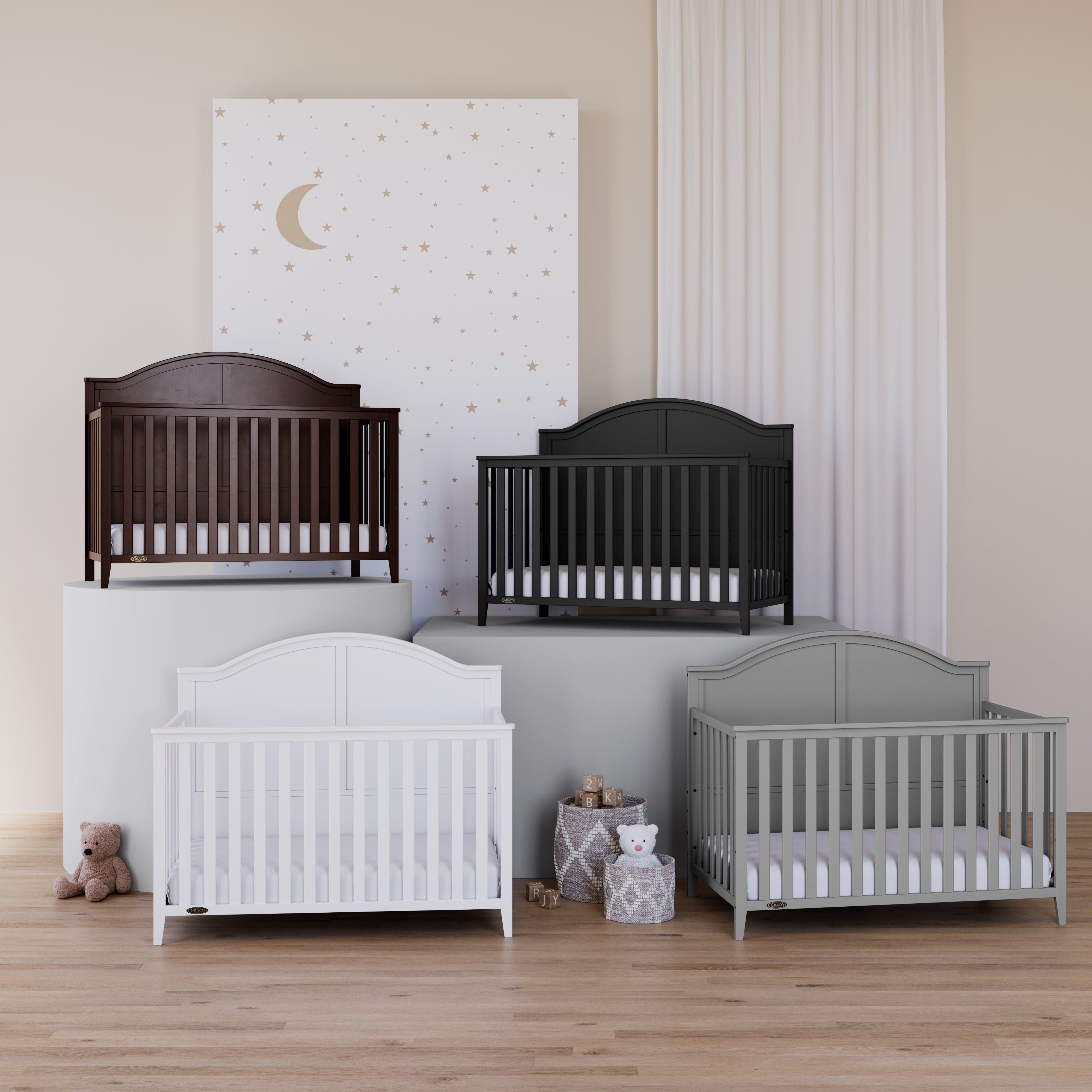 four white, espresso, black and pebble gray cribs in nursery