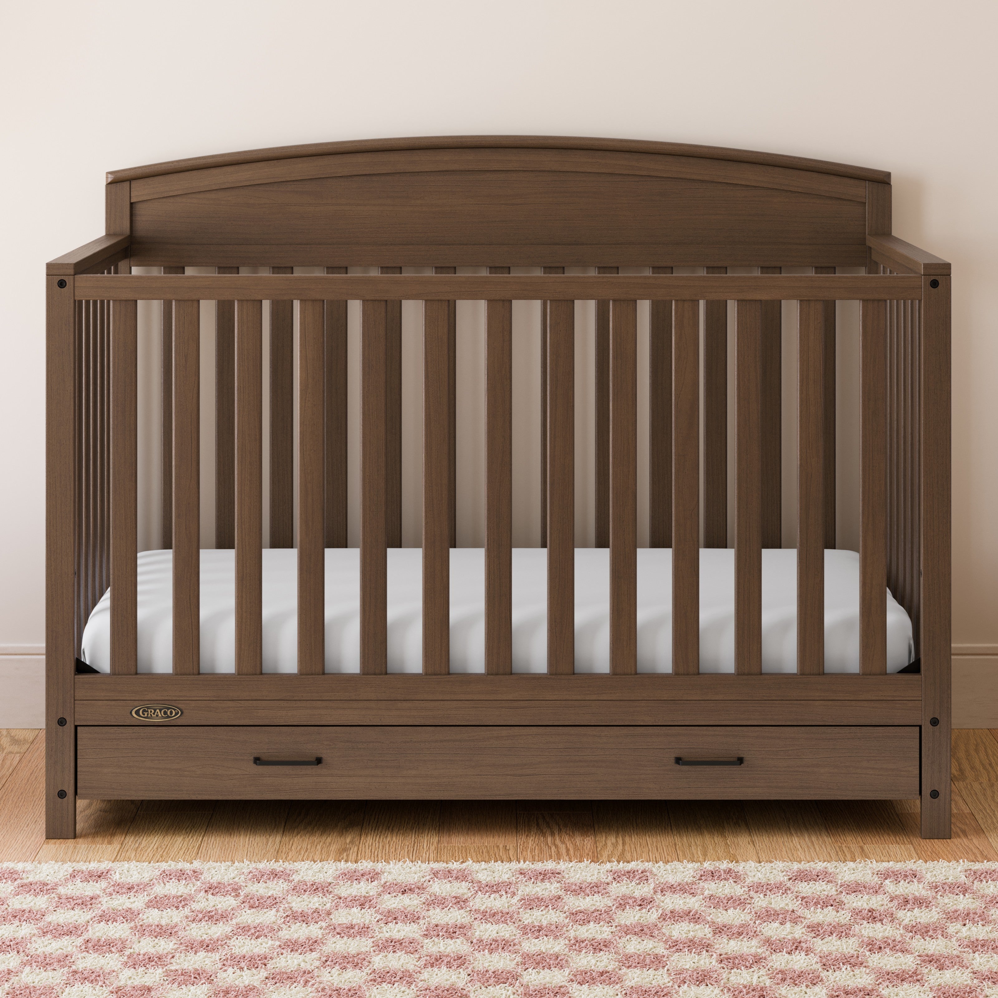 Benton hazelnut crib with drawer in a nursery