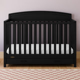 Benton black crib with drawer in a nursery
