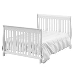 White crib in full-size bed with headboard and footboard conversion