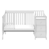 White crib in toddler bed conversion with one safety guardrail