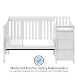 White crib in toddler bed conversion with one safety guardrail with graphic