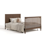 Hadley hazelnut crib and changer with drawer open converted to full-size bed with footboard