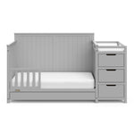 Pebble gray crib and changer with drawer in toddler bed conversion with one safety guardrail