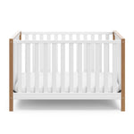 Front view of white crib with driftwood