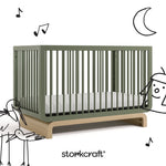 Santorini olive with driftwood crib with black cartoon drawings