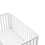 top view of a white crib with a natural wood color base