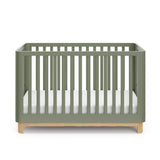 Front view of an olive crib with a natural wood color base