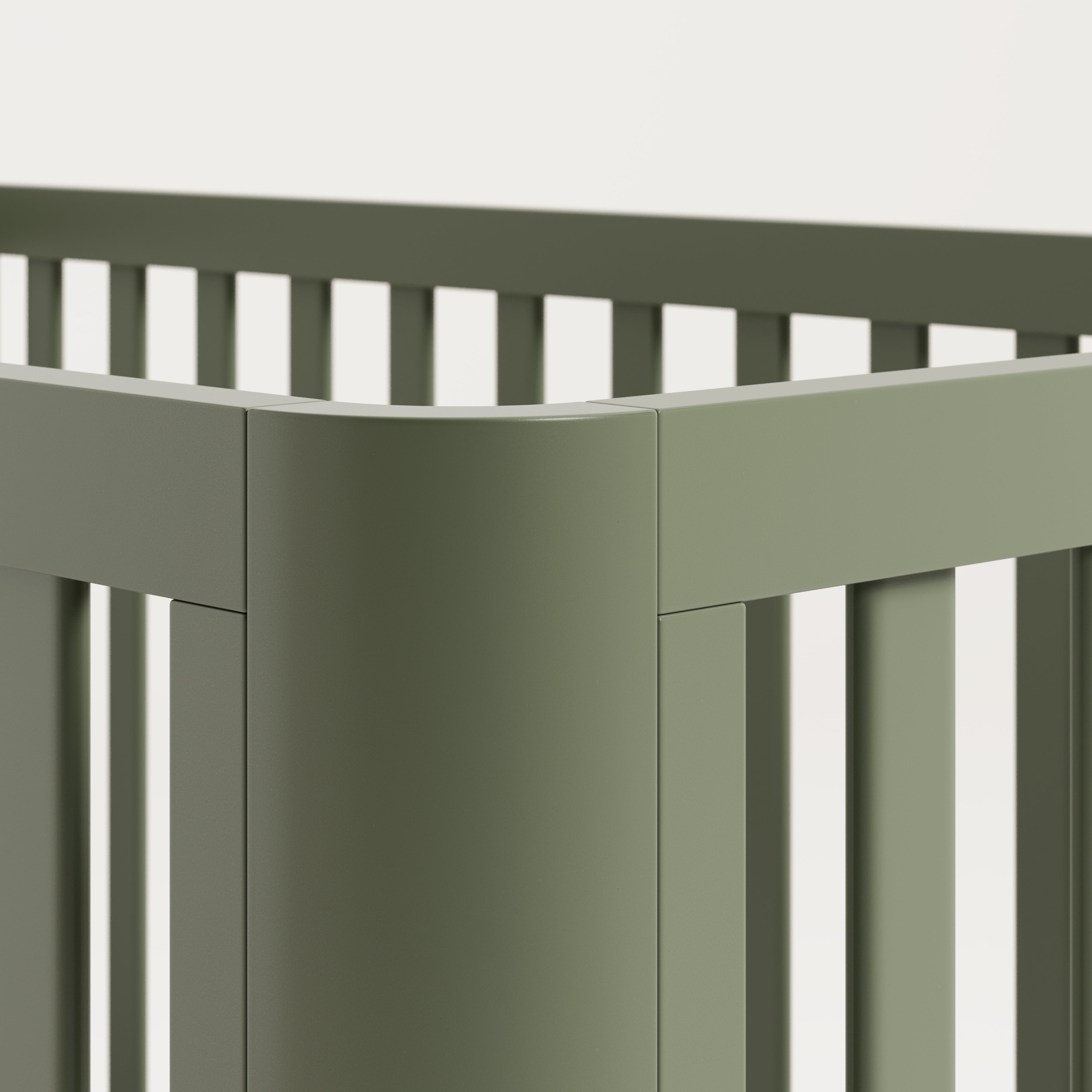 Close view of the rounded posts of an olive crib.