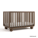 Amalfi hazelnut crib angle view with 2025 Storkcraft copyright on bottom right