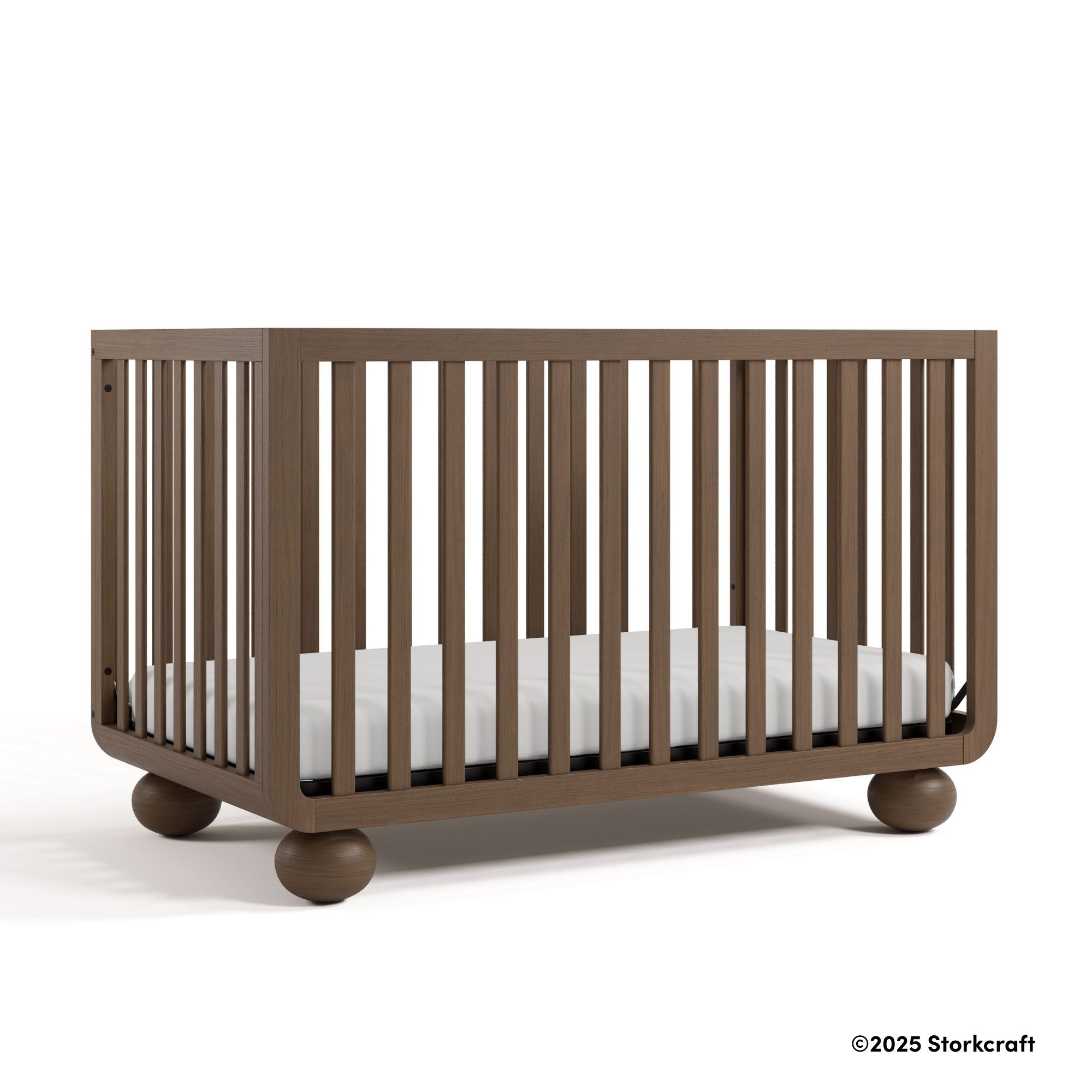 Amalfi hazelnut crib angle view with 2025 Storkcraft copyright on bottom right