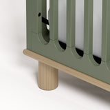 Sicily olive with driftwood crib close up of rounded feet