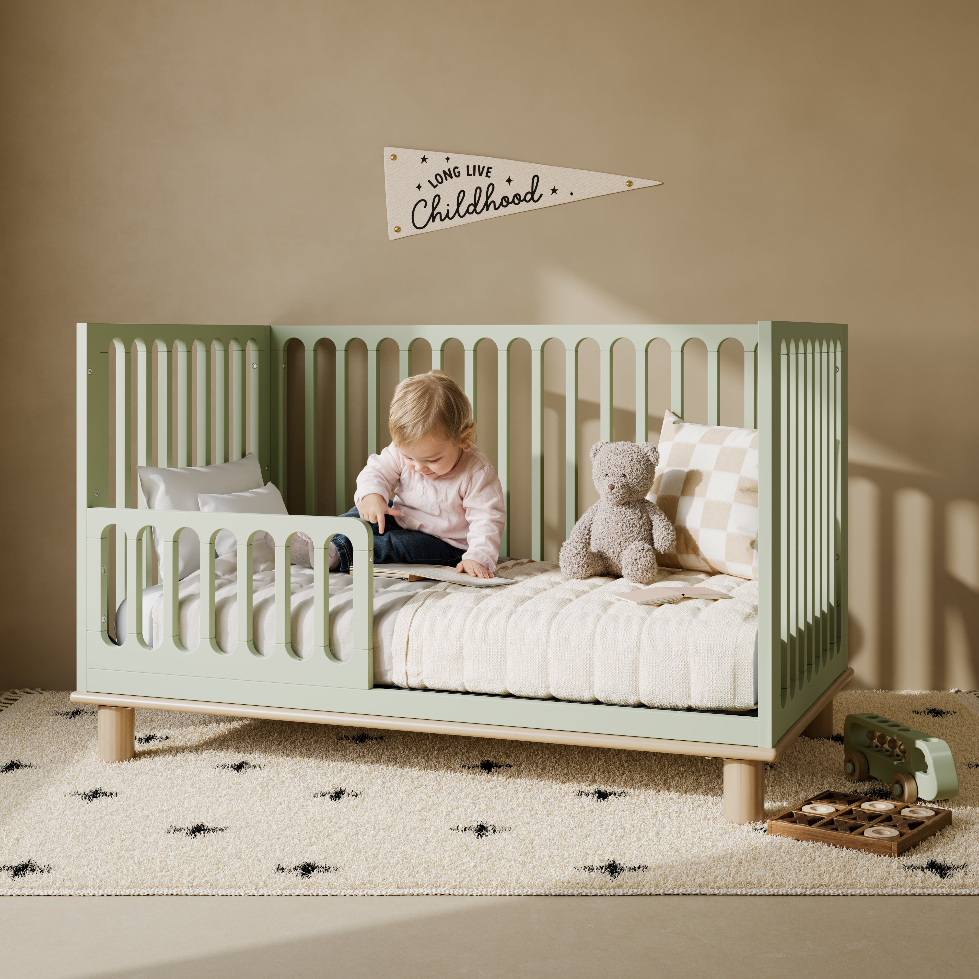 Sicily sage with driftwood crib converted to toddler bed in kids room