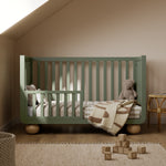 Amalfi olive with driftwood crib converted to toddler bed in a nursery