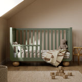 Amalfi olive with driftwood crib converted to toddler bed in a nursery