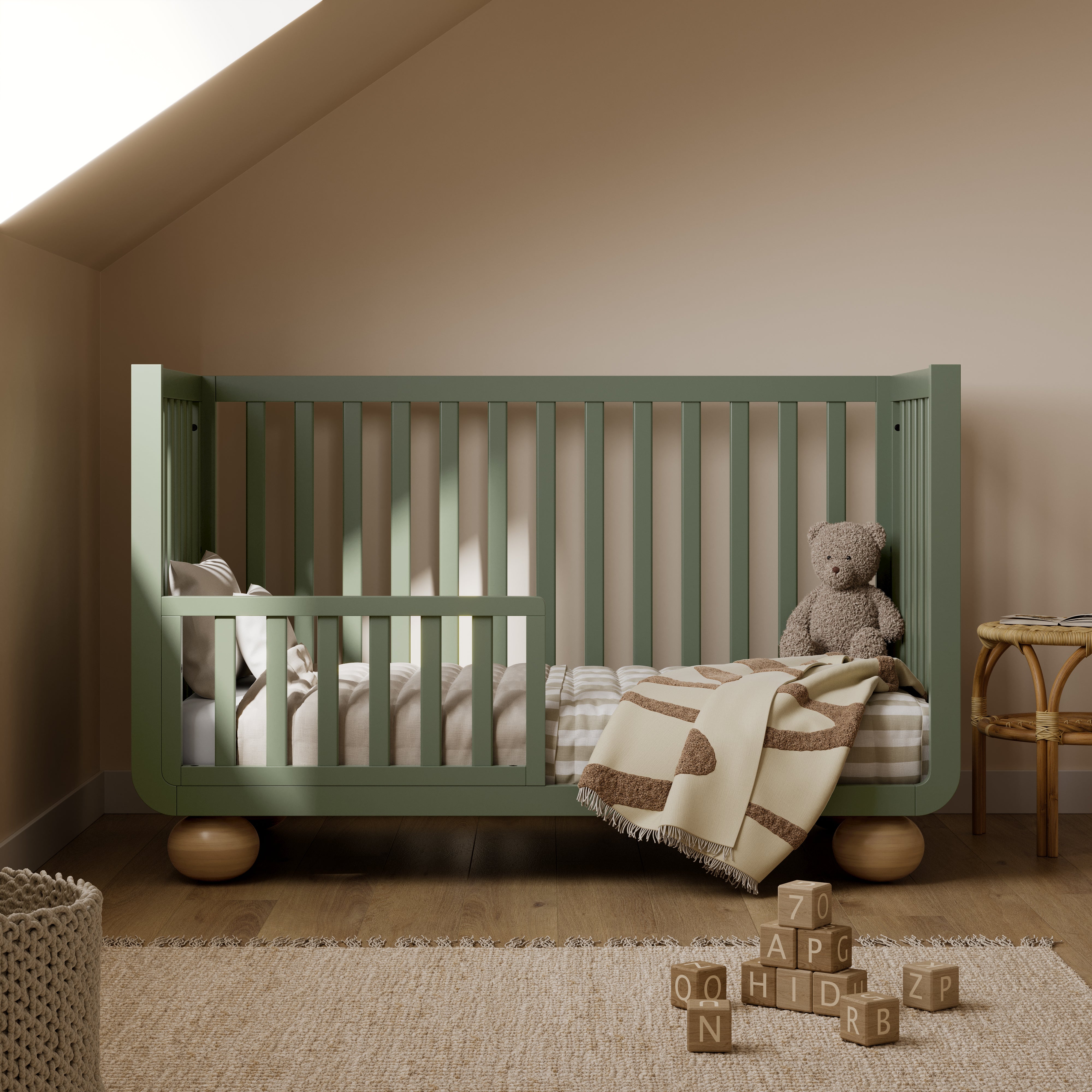 Amalfi olive with driftwood crib converted to toddler bed in a nursery