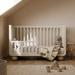 Amalfi frosted oat with driftwood crib converted to toddler bed in a nursery