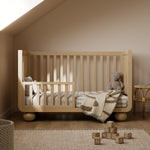 Amalfi driftwood crib converted to toddler bed in a nursery